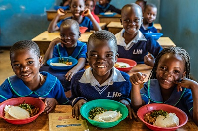 ERDO - Children enjoying lunch at the tutoring program held at Village of Hope in Malawi.