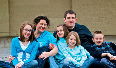 Family photo of Irislee, her husband, Derek, and their four children