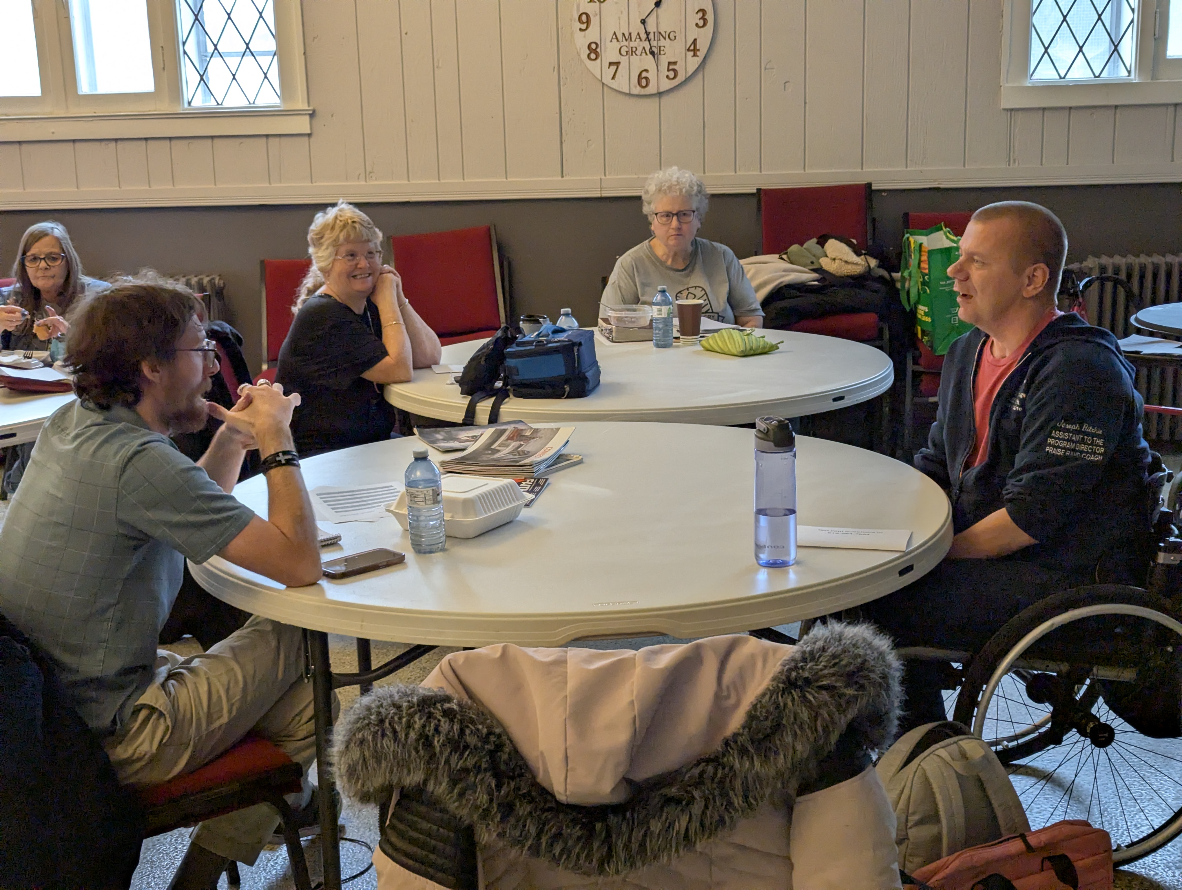 People sitting at round tables talking to each other.
