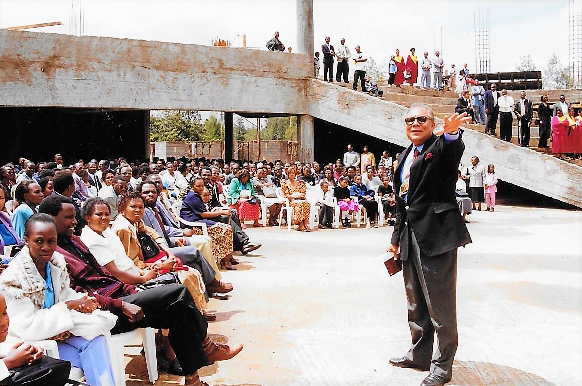 Pastor Dennis ministers with church under construction