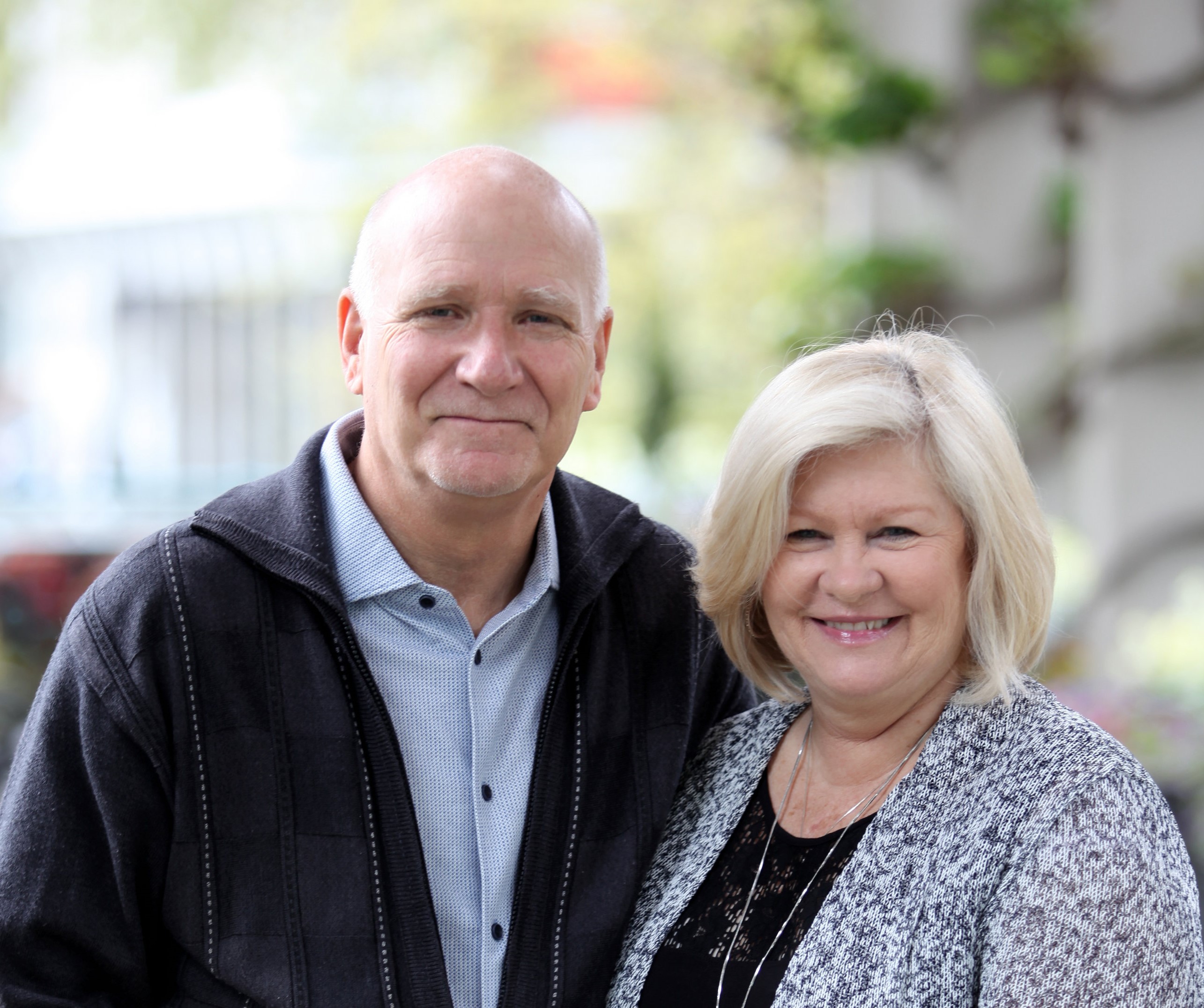 A headshot of Murray and Cindy Cornelius standing in the sunlight.