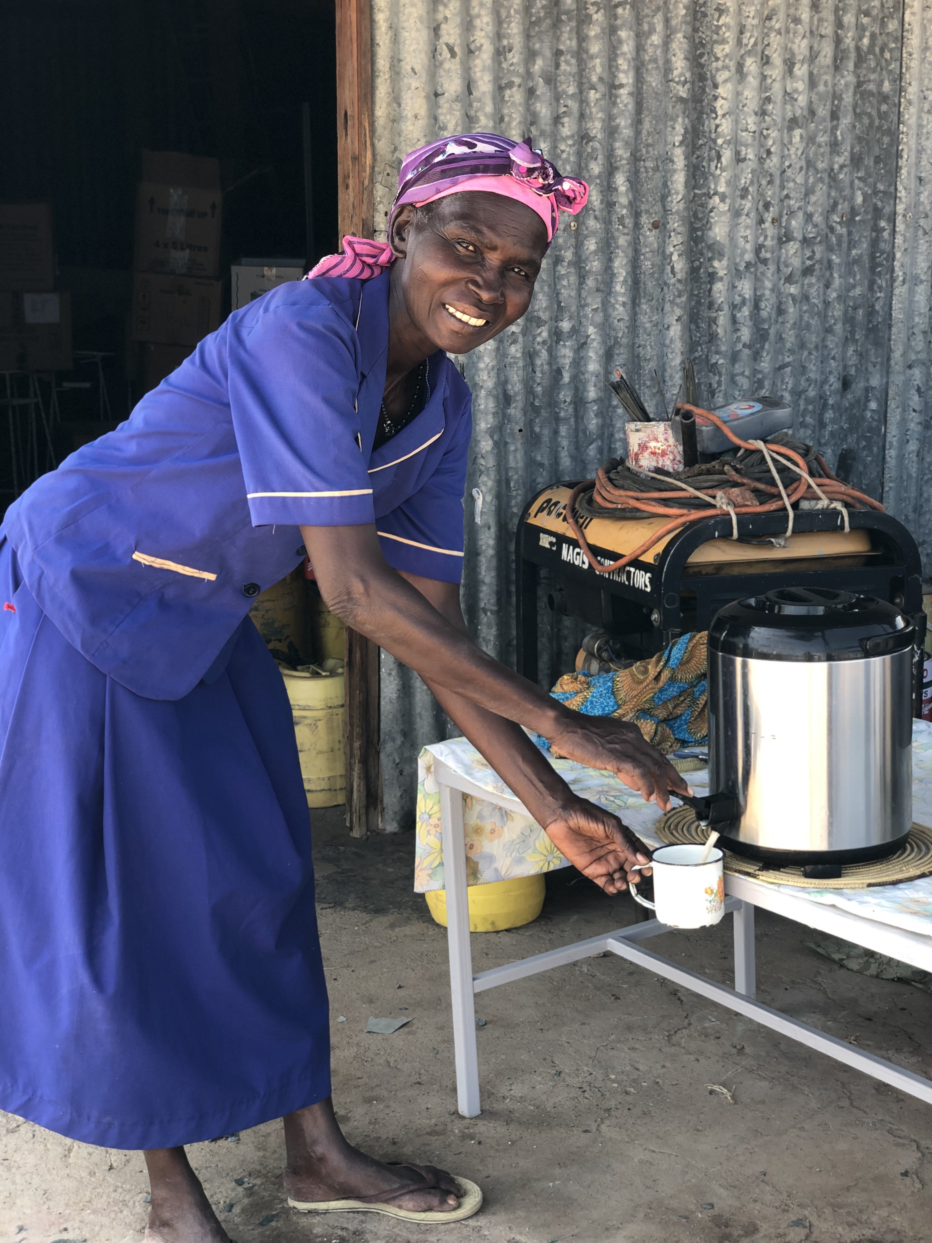 Kenyan woman getting something to drink